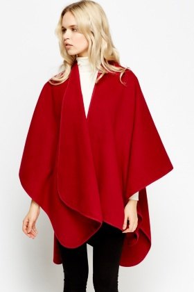red fleece poncho with white mock neck sweater
