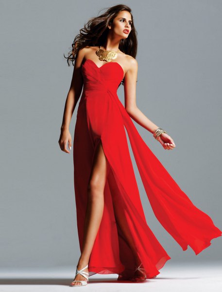 red, high-parted, floor-length dress with statement chain