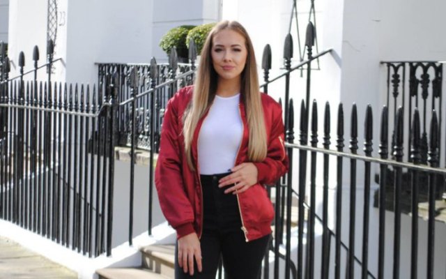 red jacket with a white, figure-hugging top and black jeans with a high waist