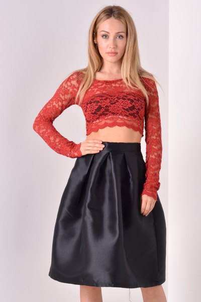 red, long-sleeved, figure-hugging crop top with black flared midi skirt