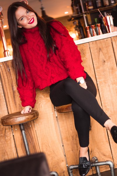 red knitted sweater with stand-up collar and black slim fit jeans