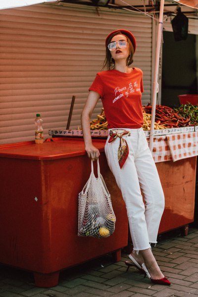 red printed t-shirt with white, cropped straight-leg jeans