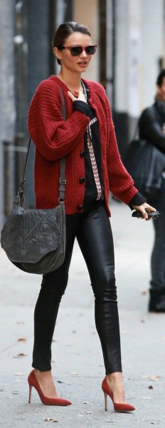red ribbed cardigan with black top and leather gaiters