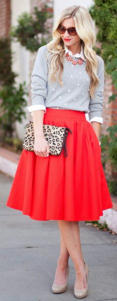red skirt gray sweater cheetah bag