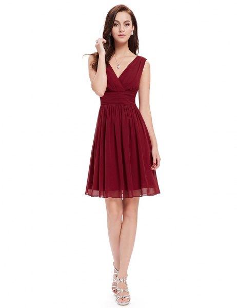 red cocktail dress with V-neckline and silver strappy high heels