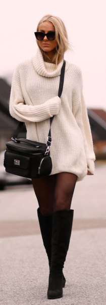 ribbed white sweater dress with black stockings and knee-high boots