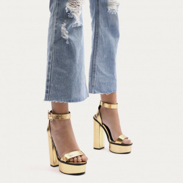 ripped flared jeans with gold platform heels