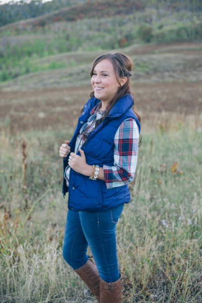 Royal blue down vest with checked boyfriend shirt and gray knee-high boots