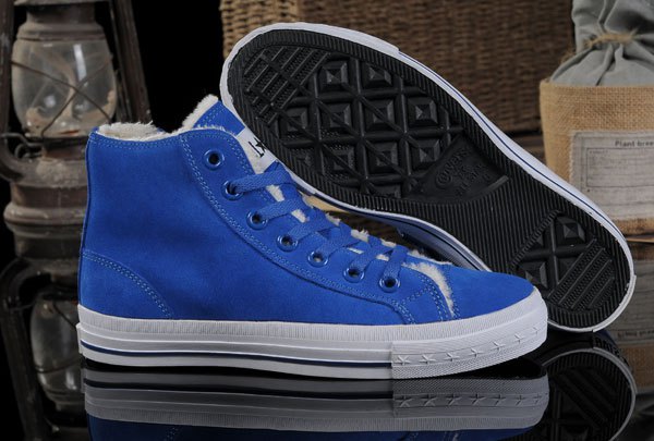 Royal blue high top Converse with white printed t-shirt and jeans