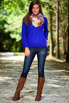 Royal blue sweater with floral printed silk scarf and knee-high boots