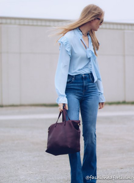 light blue blouse with ruffled shoulder puff sleeves and flared jeans