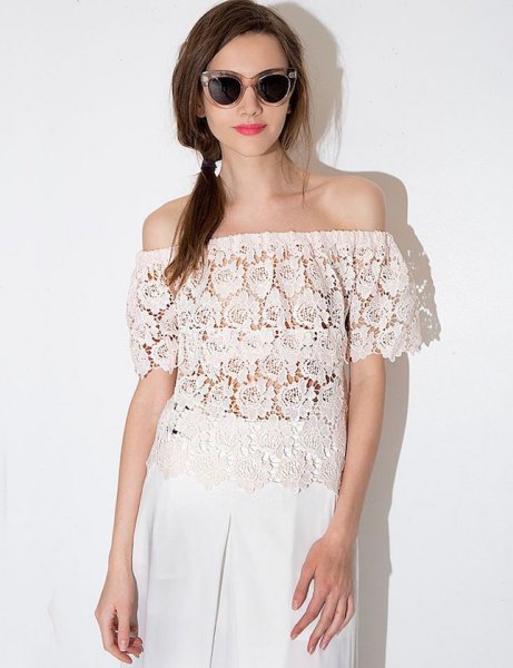 semi-transparent lace top with white linen pants with wide legs