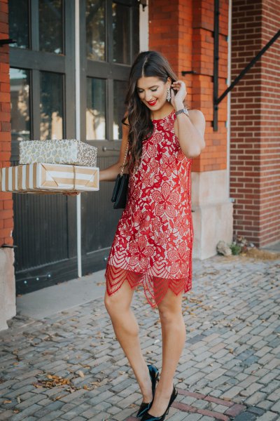 sheer red lace midi dress over a white shift dress