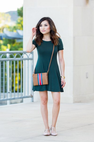 Short sleeve mini dark green skater dress with brown leather shoulder bag