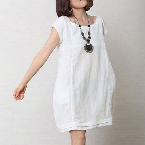 short-sleeved mini dress made of white cotton with a boho necklace