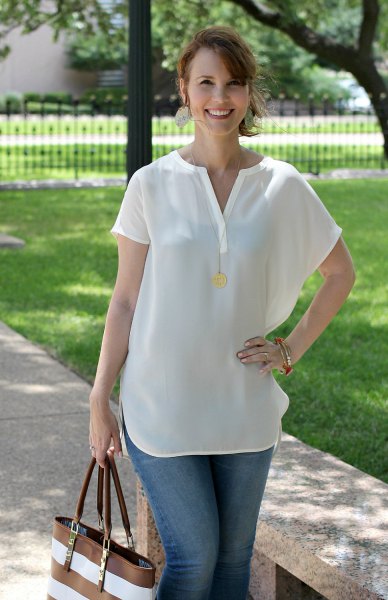 white short-sleeved blouse with V-neck and blue jeans