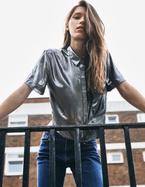 silver metallic short-sleeved shirt with blue jeans