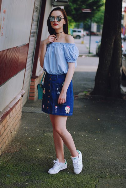 Sky blue off-the-shoulder blouse with an embroidered denim skirt with button placket