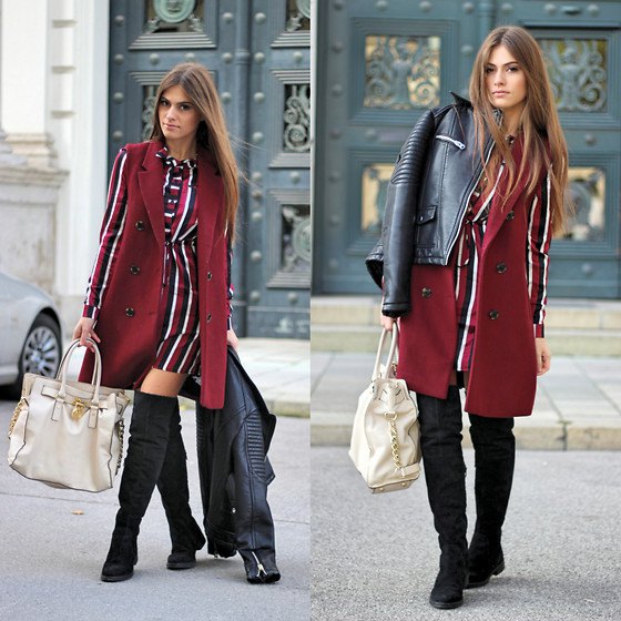 sleeveless burgundy-colored coat over a red-white-black striped long-sleeved dress