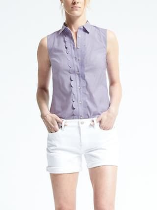 sleeveless teal shirt with white, narrow denim shorts