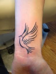 small pigeon tattoo on wrist