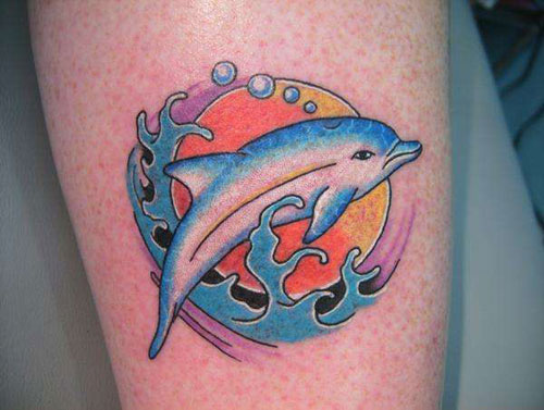 Solar dolphin tattoo on leg
