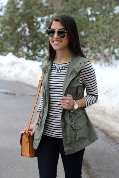 striped long-sleeved T-shirt with a silver statement chain and utility vest