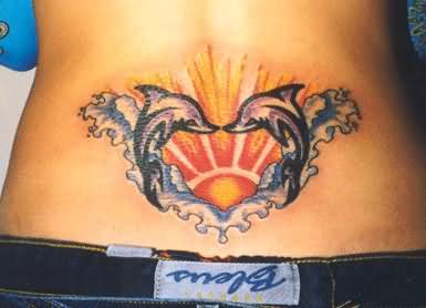 Sun dolphin tattoo lower back design
