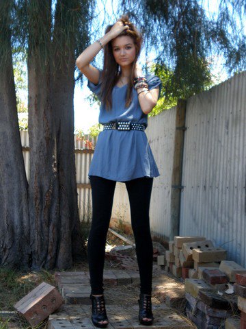 blue-green peplum top with black studded belt and leggings