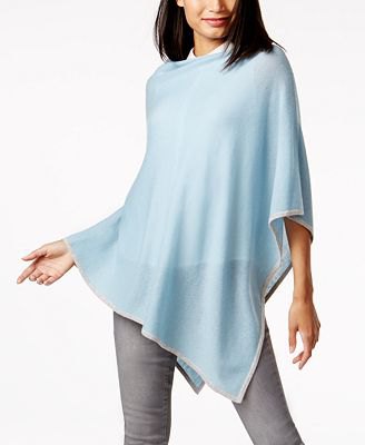 blue-green, semi-transparent cashmere poncho over a white shirt with buttons
