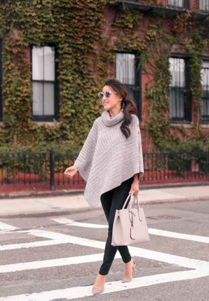 gray cape sweater with turtleneck and black slim fit trousers