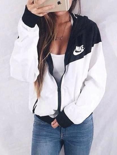 white and black Nike windbreaker with deep tank top and jeans