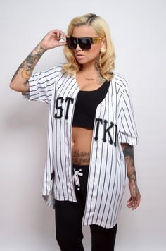 white and black oversized baseball jersey shirt with black sports bra top