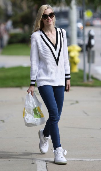 white and black ribbed sweater with V-neckline and dark blue skinny jeans