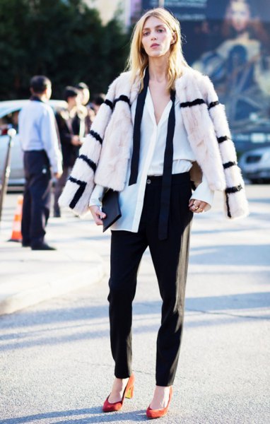 white and black striped faux fur coat with black chinos and orange heels