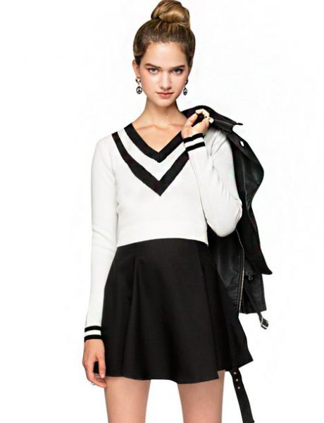 white and black sweater with V-neck and high-waisted minirater skirt