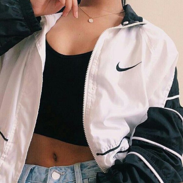 white and black windbreaker with crop top and denim mini shorts