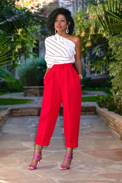 white and gray striped one-shoulder top and red wide-leg pants