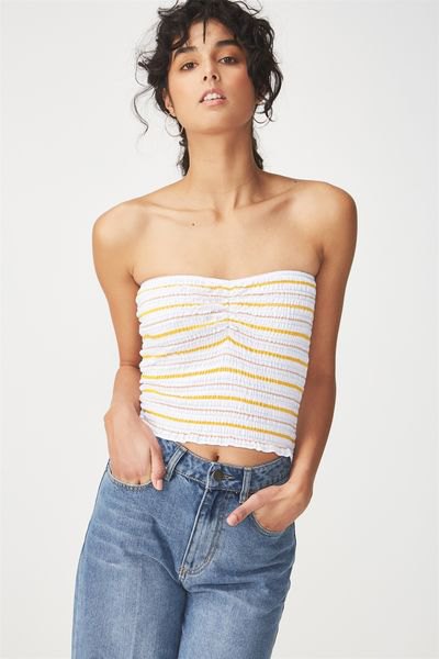 white and orange striped short tube top with blue jeans with straight legs