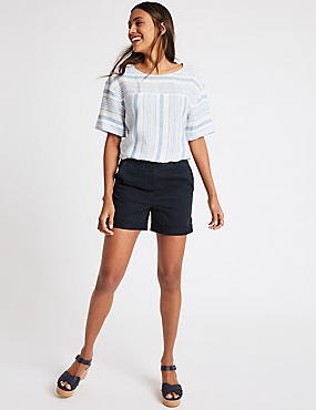 white and light blue t-shirt with dark blue shorts