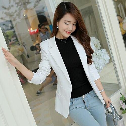 white blazer with black sweater with round neckline and light blue jeans