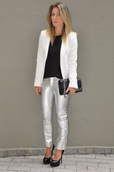 white blazer with a black top with a round neckline and silver metallic jeans