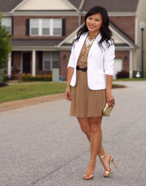 white blazer with a blushing pink mini pleated skirt and gold heels