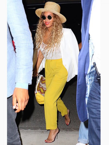 white blazer with mustard-yellow trousers with straight legs and straw hat