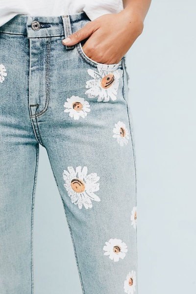 white blouse with light blue skinny jeans with a floral pattern