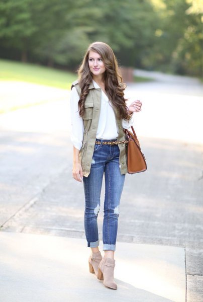 white blouse with a light brown vest and gray suede boots