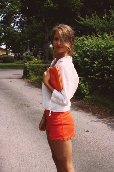 white blouse with orange shorts with scalloped hem