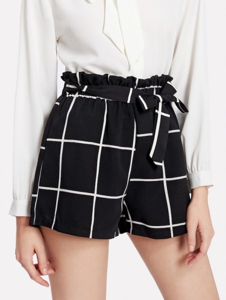 white blouse with buttons and black checked shorts