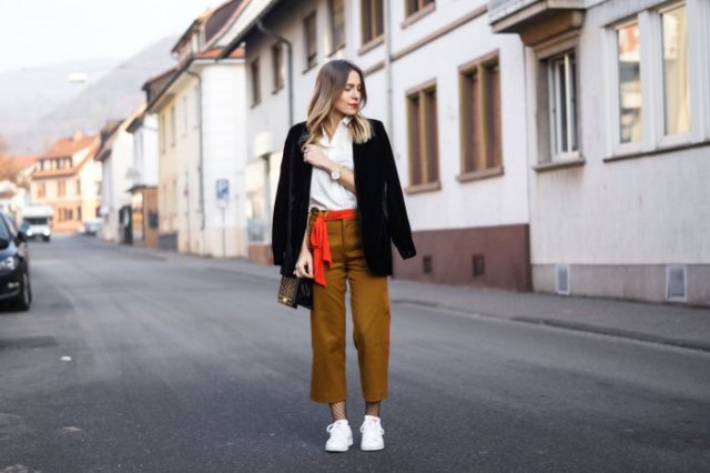 white shirt with buttons, black blazer and dark mustard trousers with straight legs