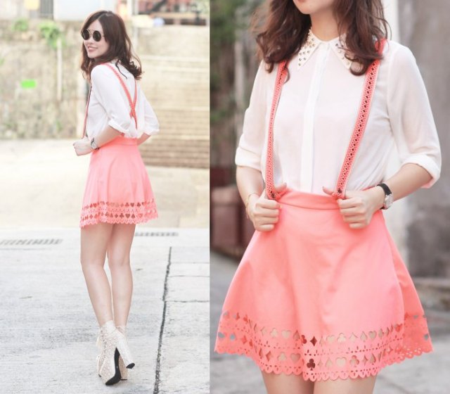 white shirt with buttons and blushing pink suspender mini skirt